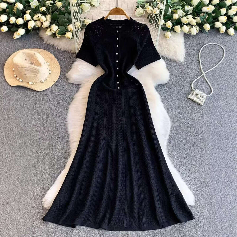 2026 French luxury socialite hollow round neck knitted women's autumn and winter high-end pearl slim elegant long skirt