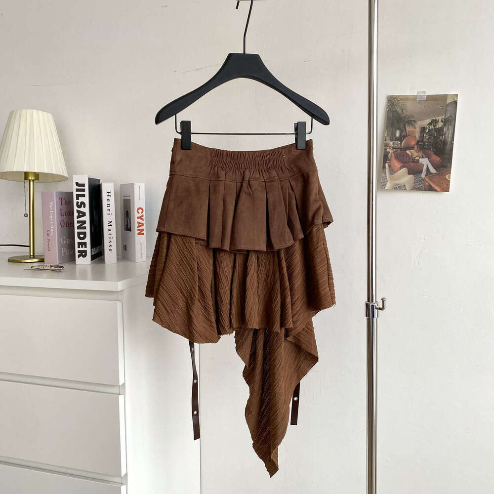 Design a niche multifunctional women's irregular skirt in 2026 autumn and winter, featuring an American retro style with a belt and ruffles
