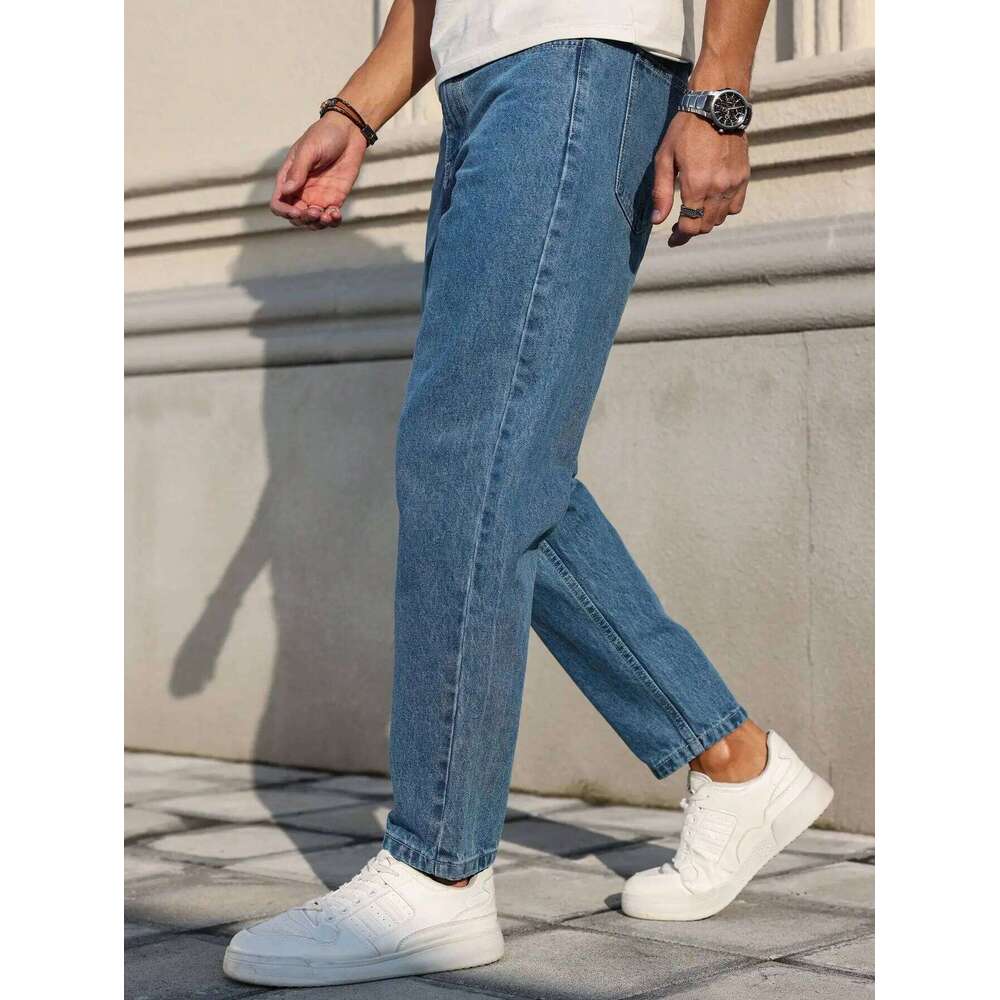 Men's jeans are made of classic blue denim fabric with a loose fit, making them an indispensable versatile item in the wardrobe.