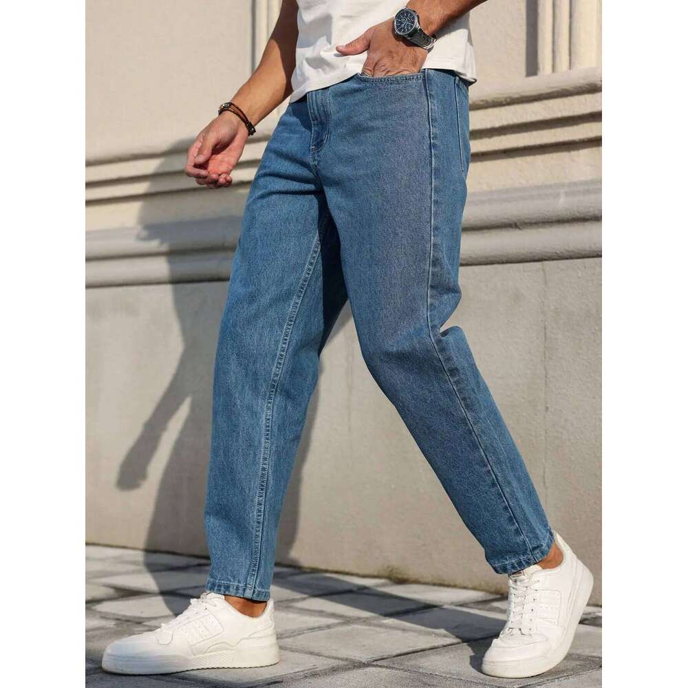 Men's jeans are made of classic blue denim fabric with a loose fit, making them an indispensable versatile item in the wardrobe.