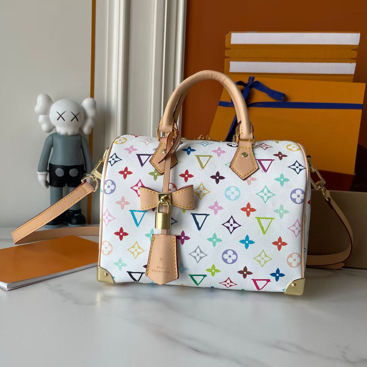Designer bag Monogram canvas and cowhide trimmed with vintage flowers in 33 vibrant colors, showcasing white tri color and black tri color, launching a travel handbag