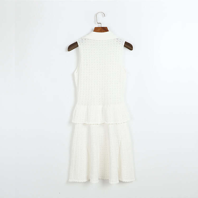 j29 Designer's mid length knitted dress for summer and autumn, sleeveless and foldable, with gold buttons at the waist and pleated hem at the hem