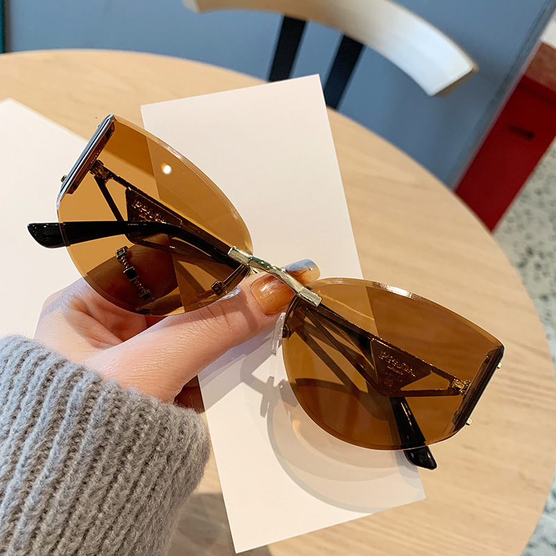 2026 Frameless Designer Sunglasses Luxury Brand Fashion Accessories New Women's Cat Eye Cutting Edge Hollow Leg Women's Outdoor Glasses Casu