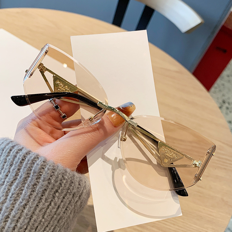 2026 Frameless Designer Sunglasses Luxury Brand Fashion Accessories New Women's Cat Eye Cutting Edge Hollow Leg Women's Outdoor Glasses Casu