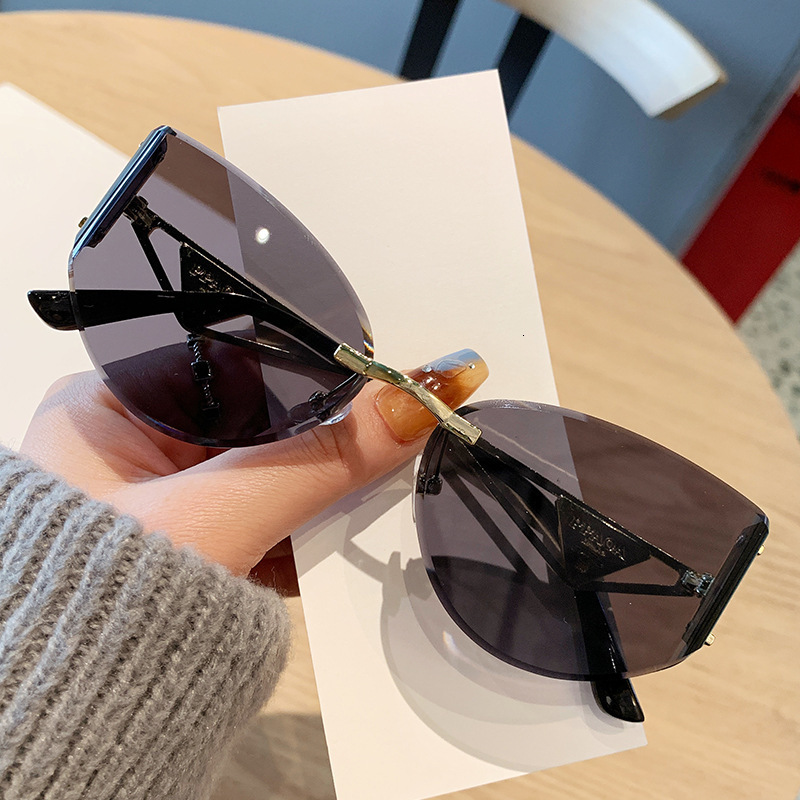 2026 Frameless Designer Sunglasses Luxury Brand Fashion Accessories New Women's Cat Eye Cutting Edge Hollow Leg Women's Outdoor Glasses Casu