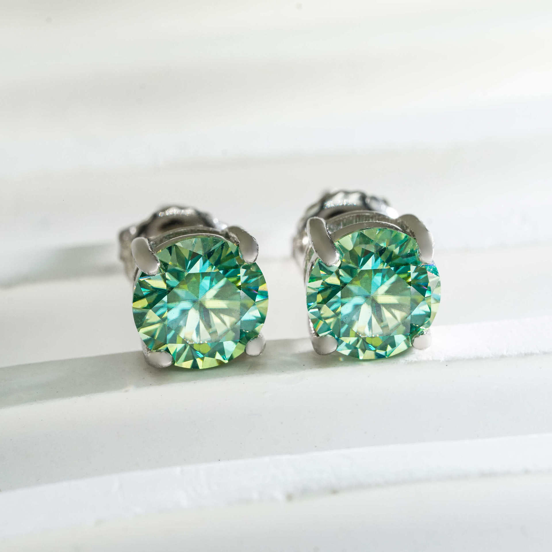 Single stone four-prong blue-green moissanite stud earrings S925 silver unisex available in multiple sizes simple earrings