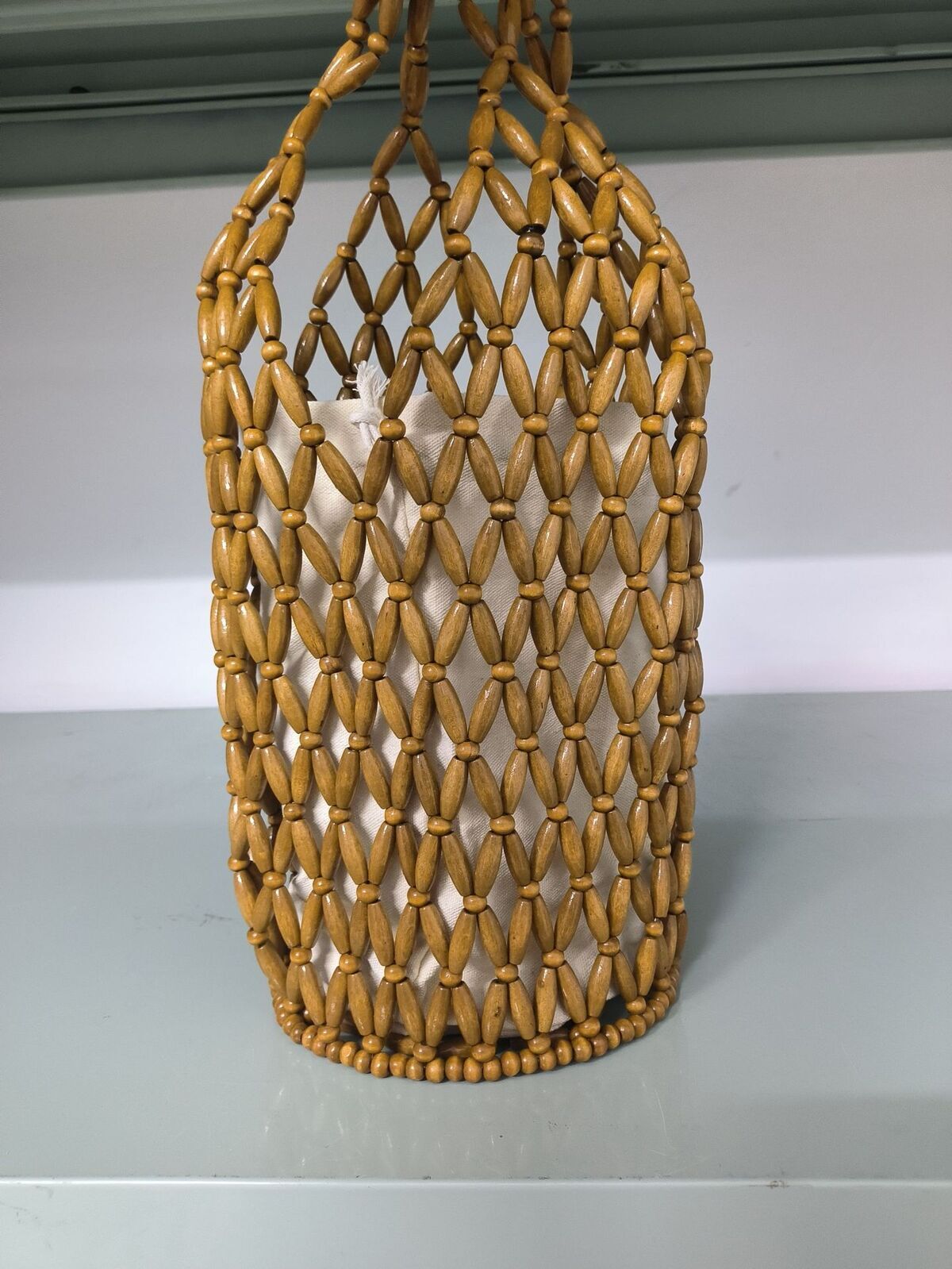 Handmade woven bag for women, cross-border niche design in Europe and America, hollowed out wooden bead bag, hand-held water bucket shoulder bag, mesh