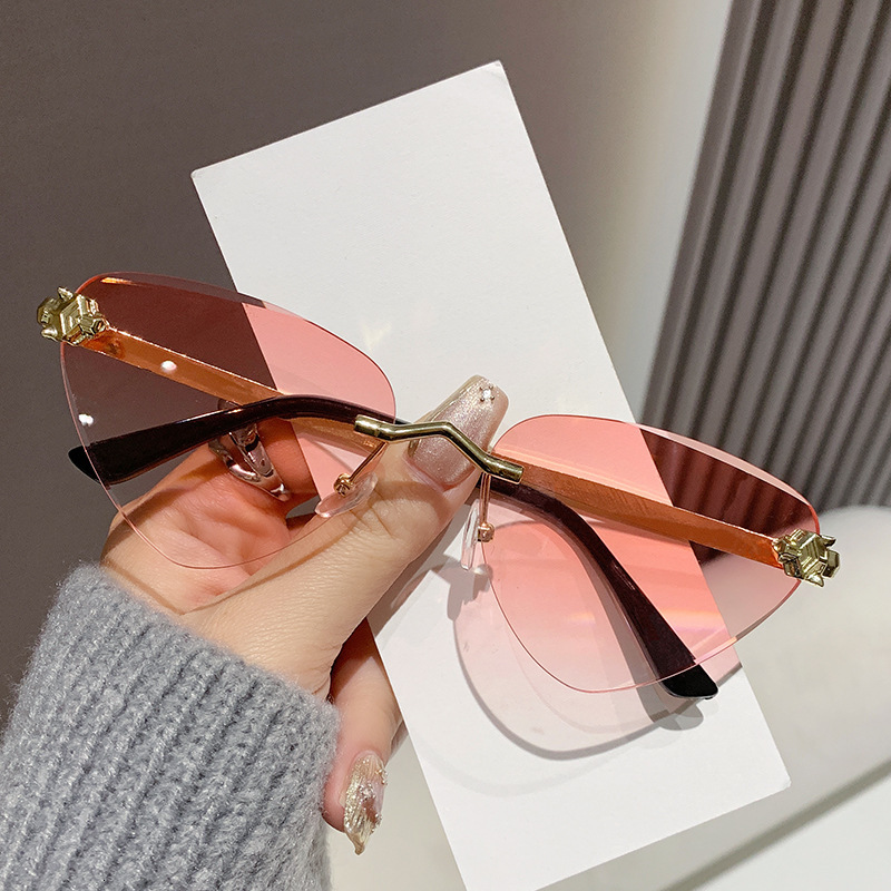 Cross Border Luxury Cat Eye Ocean Lens Designer Sunglasses New Metal Cutting Edge Outdoor Sunshade Sunglasses Runway Show Cheetah Triangle Glasses