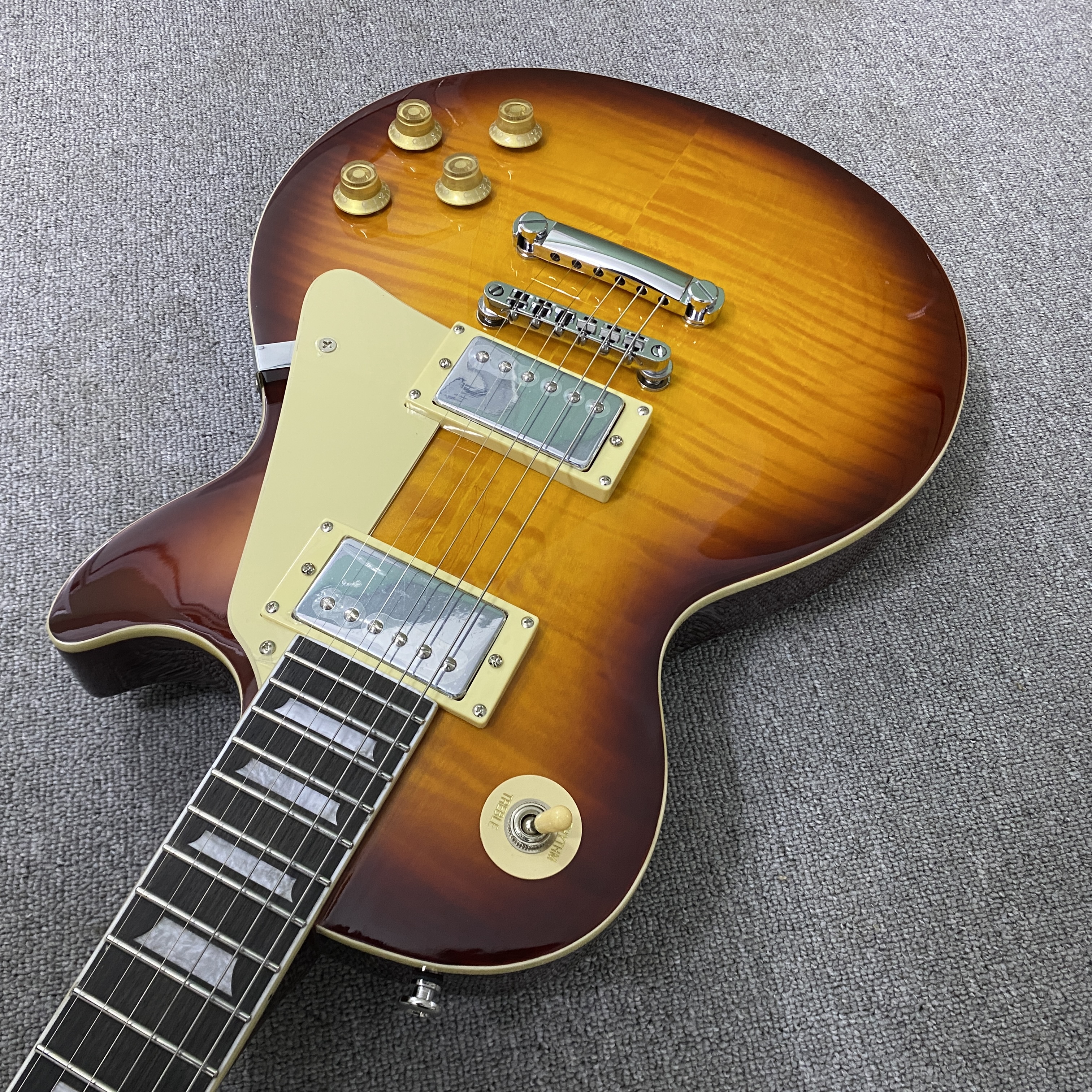 High-quality 6-string electric guitar with flame wood veneer, solid body, chrome hardware, HH pickups, mahogany body. Free shipping.