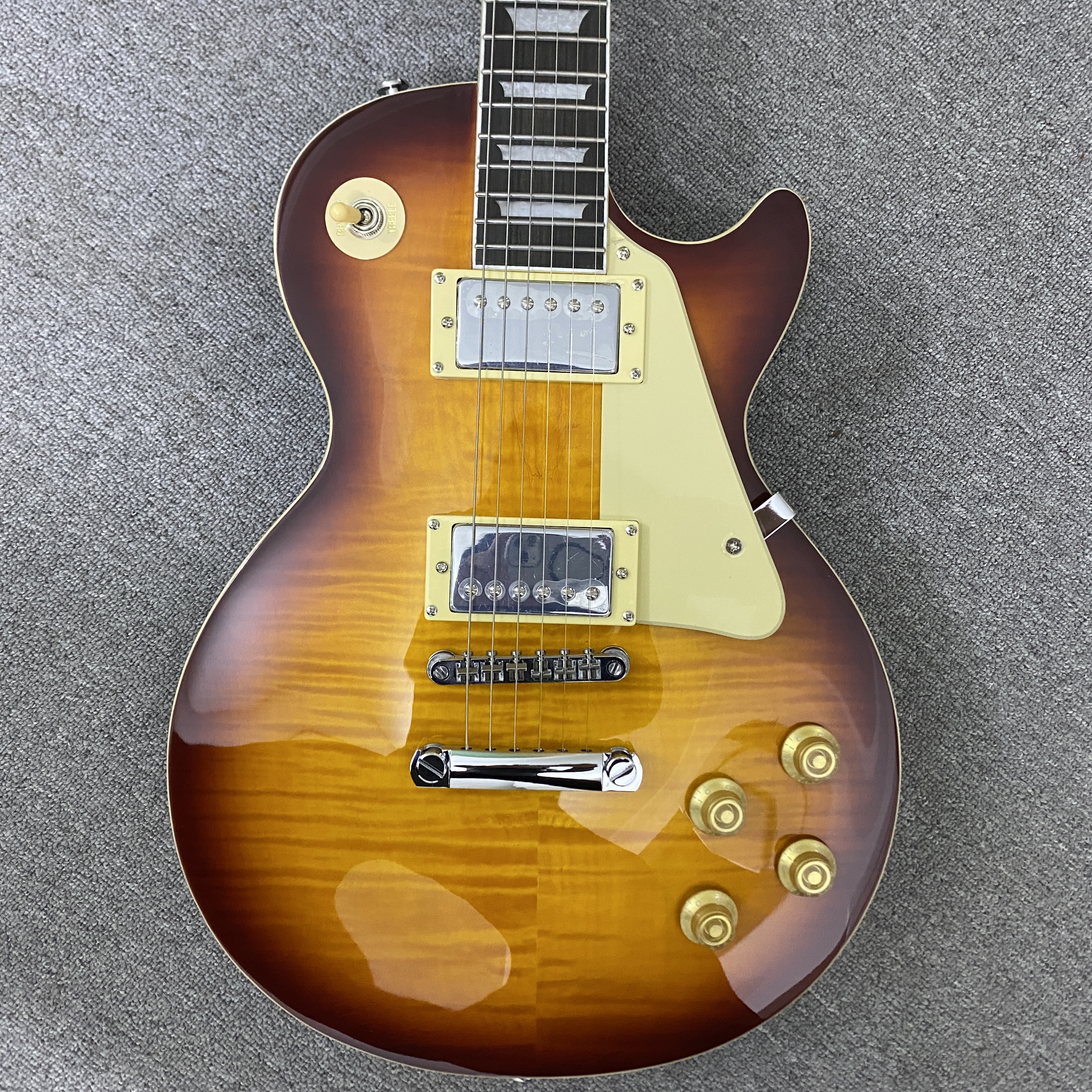High-quality 6-string electric guitar with flame wood veneer, solid body, chrome hardware, HH pickups, mahogany body. Free shipping.