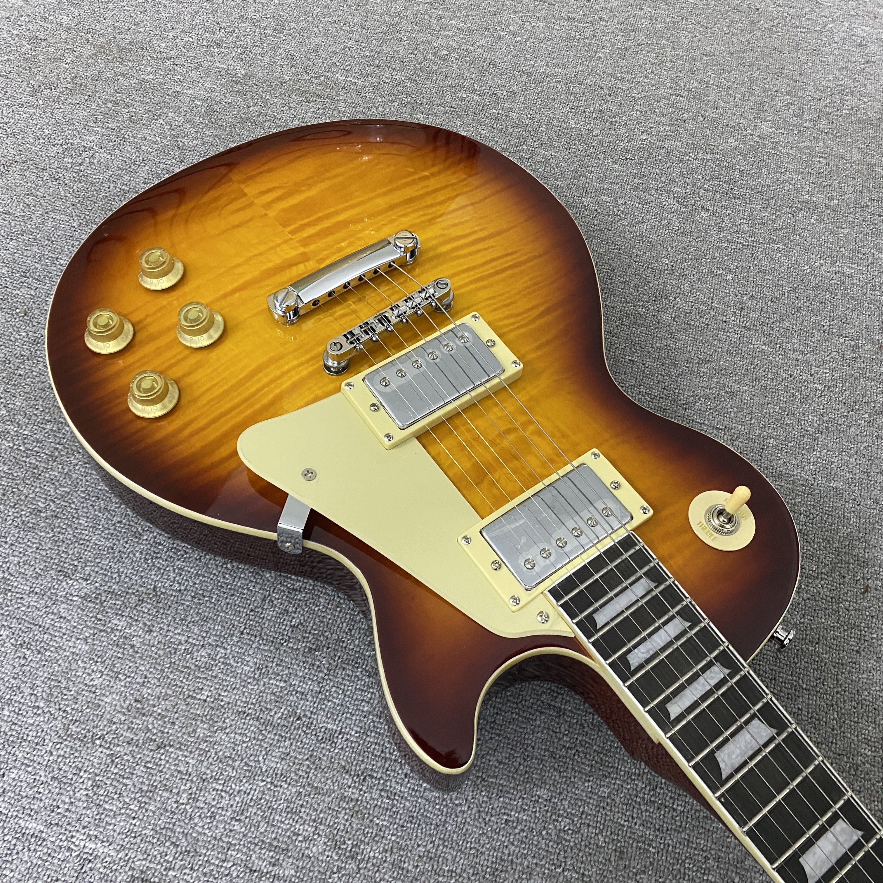 High-quality 6-string electric guitar with flame wood veneer, solid body, chrome hardware, HH pickups, mahogany body. Free shipping.