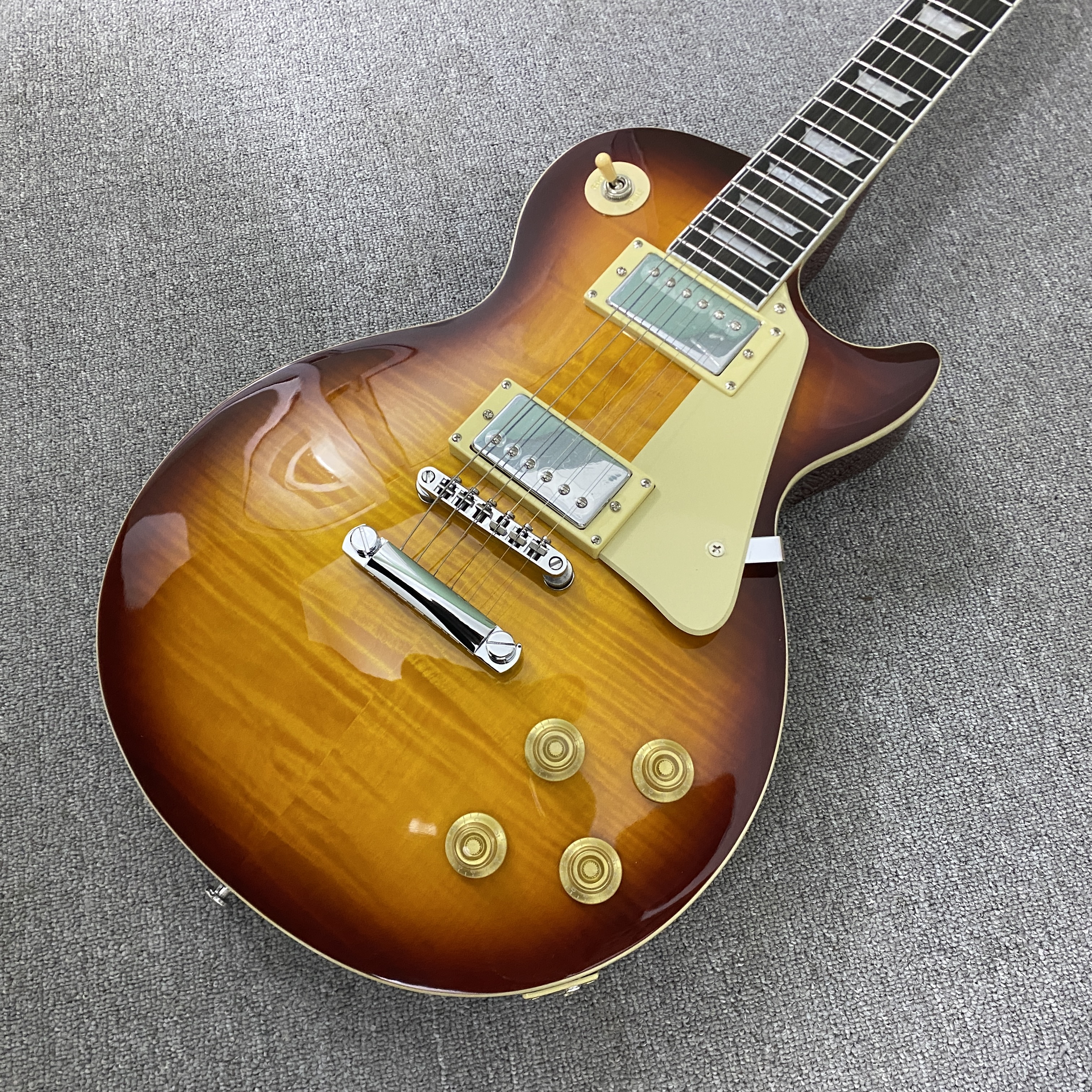 High-quality 6-string electric guitar with flame wood veneer, solid body, chrome hardware, HH pickups, mahogany body. Free shipping.