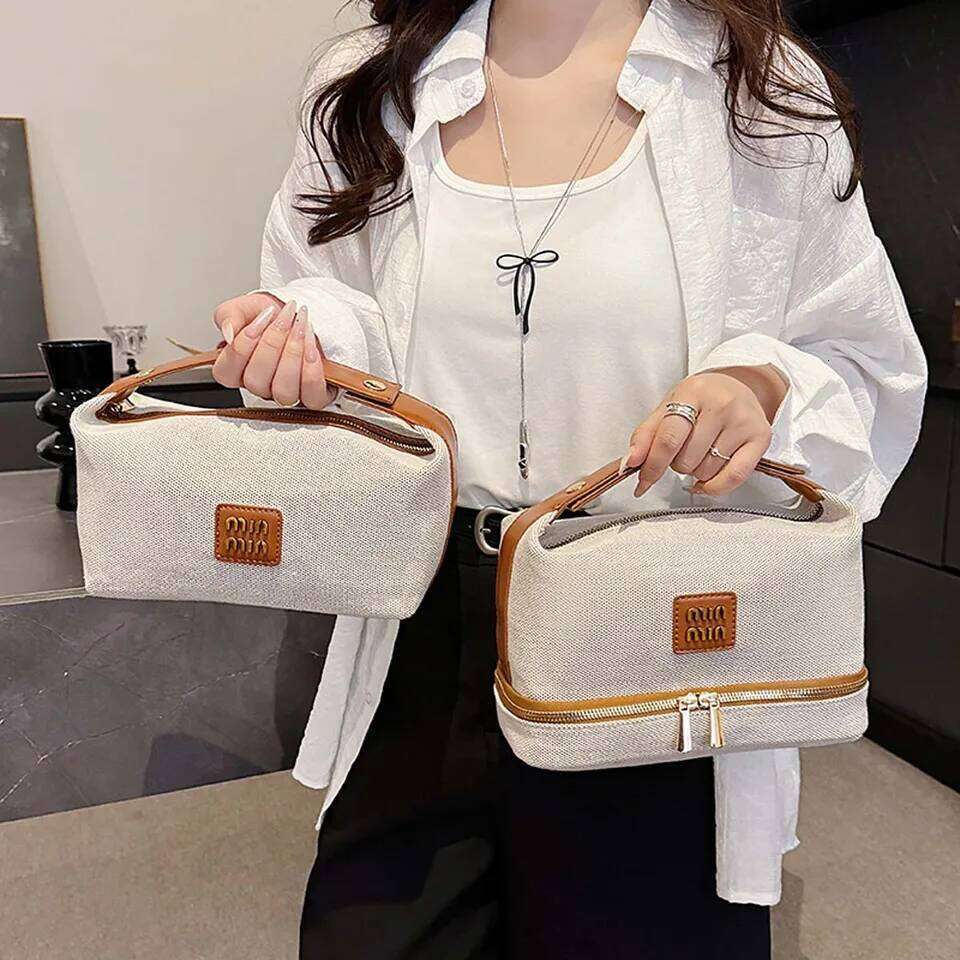Double-layer metal label cosmetic bag, retro canvas portable hand-held bag with a high-end feel for storage Y260206