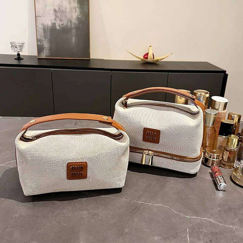 Double-layer metal label cosmetic bag, retro canvas portable hand-held bag with a high-end feel for storage Y260206