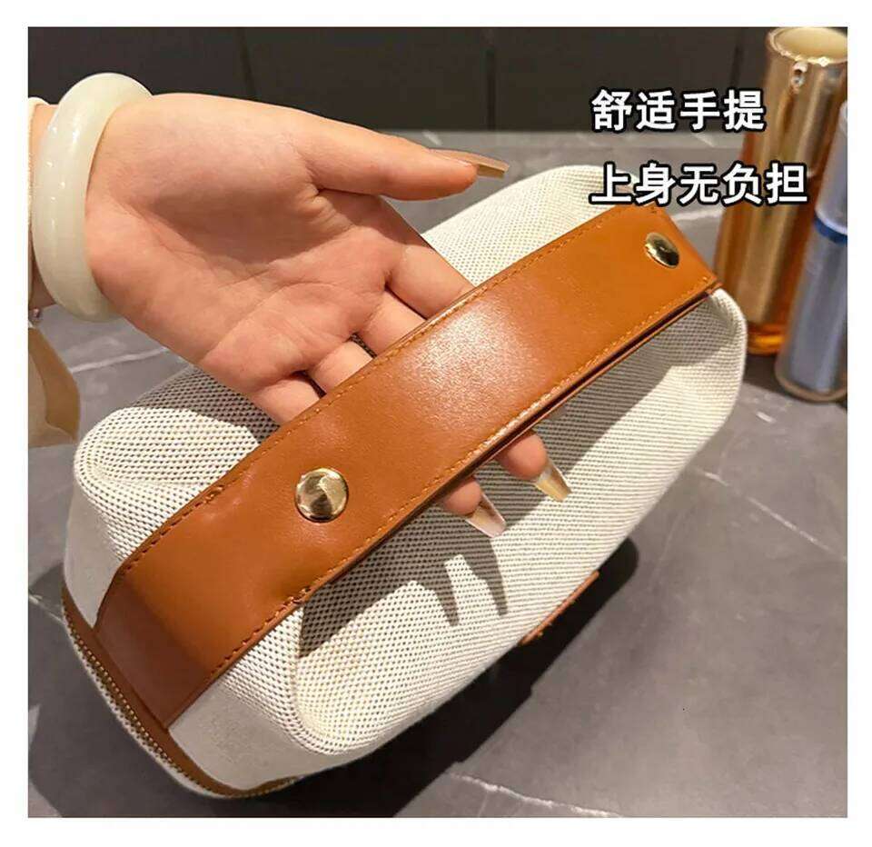 Double-layer metal label cosmetic bag, retro canvas portable hand-held bag with a high-end feel for storage Y260206