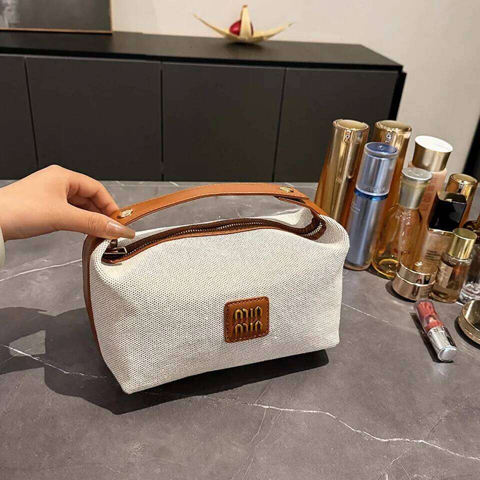 Double-layer metal label cosmetic bag, retro canvas portable hand-held bag with a high-end feel for storage Y260206