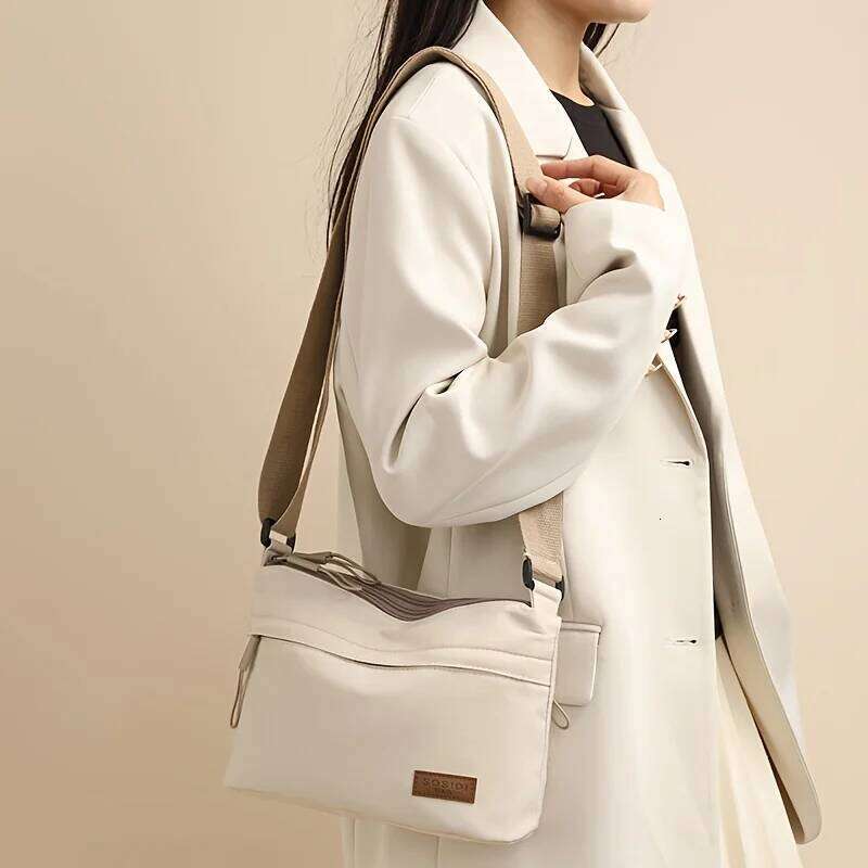 This large-capacity crossbody bag for women features a multi-zipper design and adjustable shoulder straps, making it suitable fo XJ260129