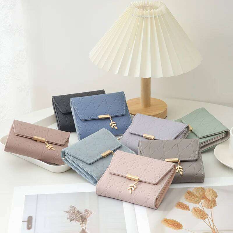Autumn winter new women's short wallet Japan and South Korea small fresh PU simple folding hardware leaf pendant three fold Y260206
