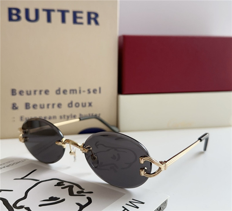 New fashion design small oval sunglasses 0551S rimless lens metal temples simple and popular style outdoor UV400 protection glasses