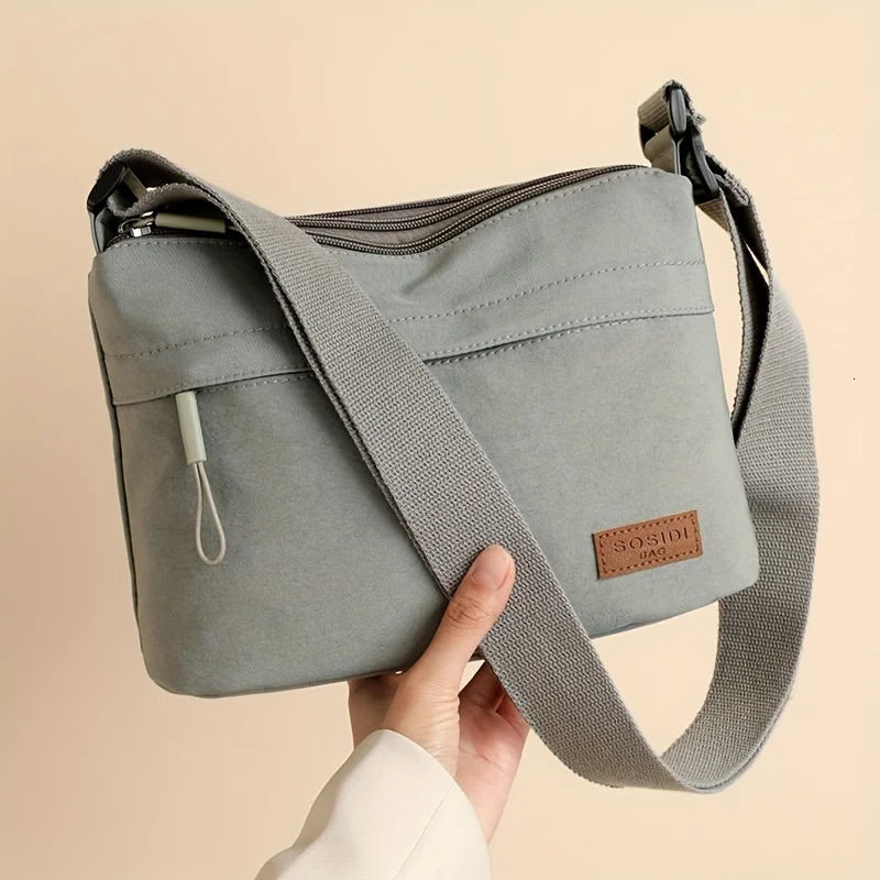 This largecapacity crossbody bag for women features a multizipper n and adjustable shoulder straps making it suitable fo 260208