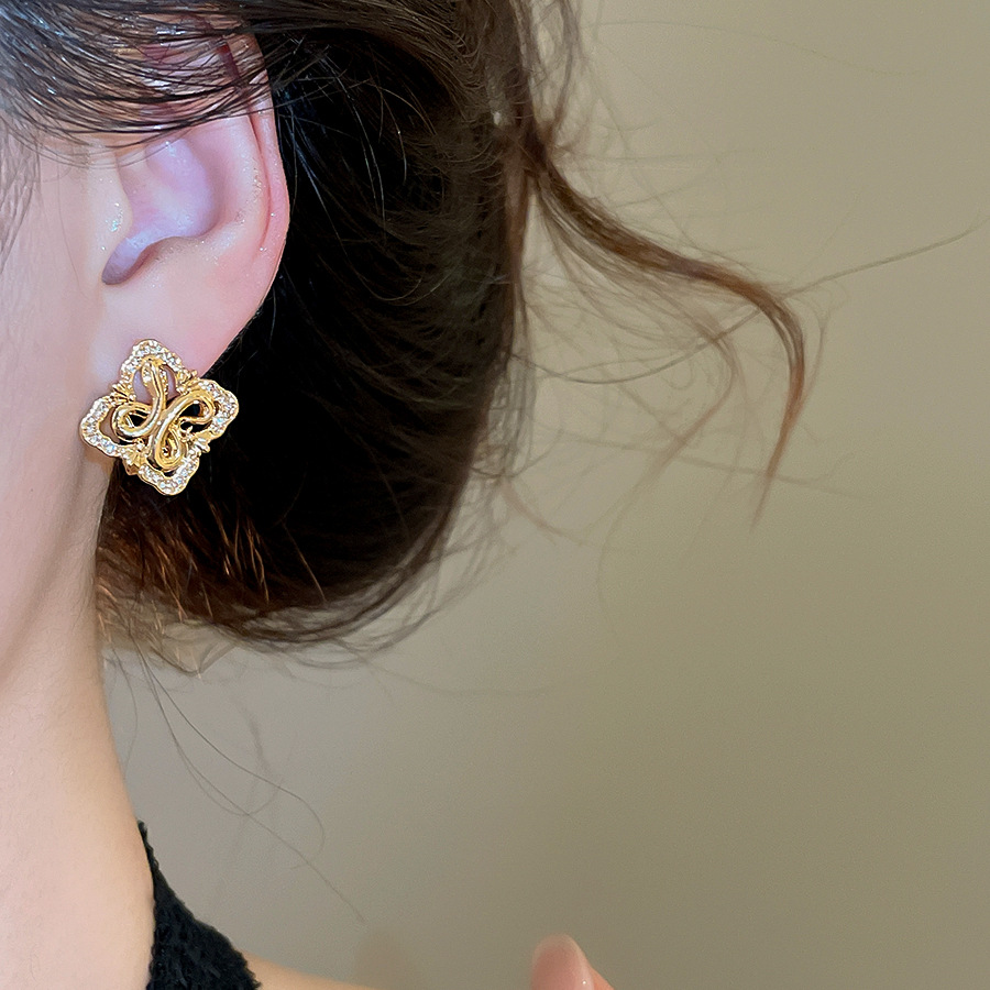 Silver needle zircon diamond-shaped hollow iris flower stud earrings, French vintage style, niche earrings with a light luxury and high-end feel - view 6