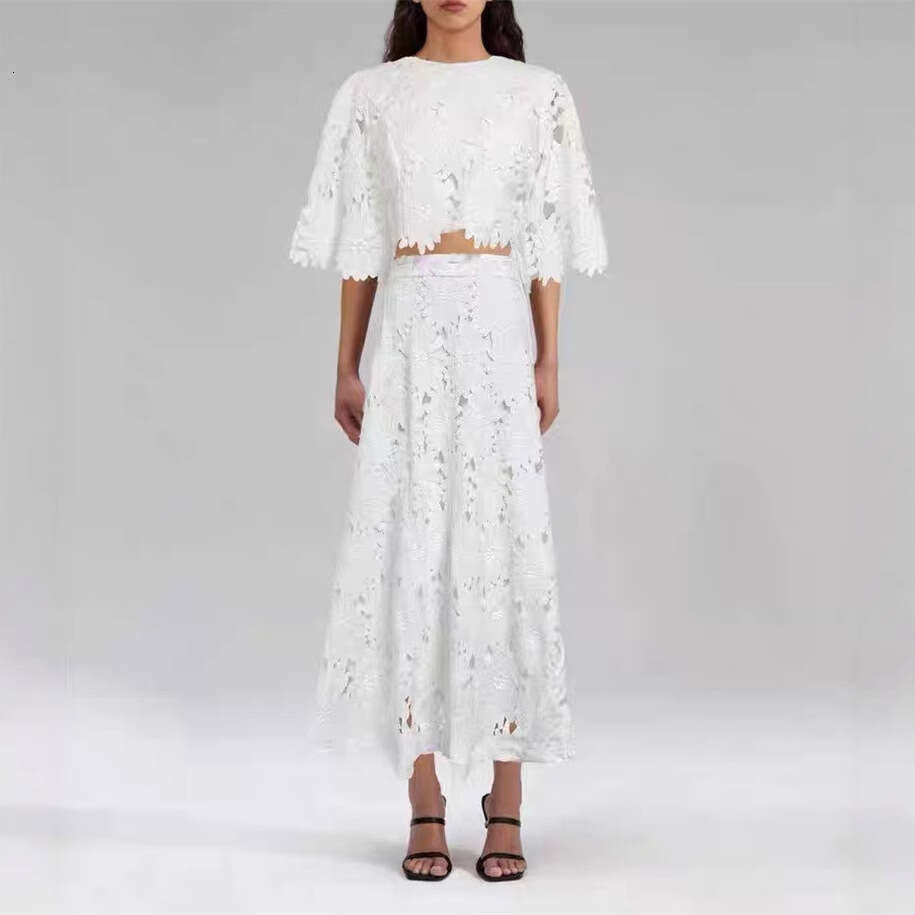 Summer 2026 European and American women's niche daisy a2 hollow lace bell sleeves short top big hem mid skirt vacation set