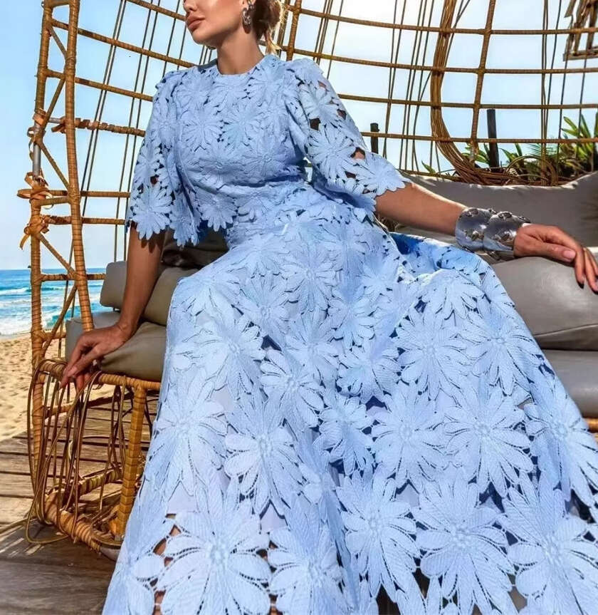 Summer 2026 European and American women's niche daisy hollow lace bell sleeves short top big hem mid skirt vacation set