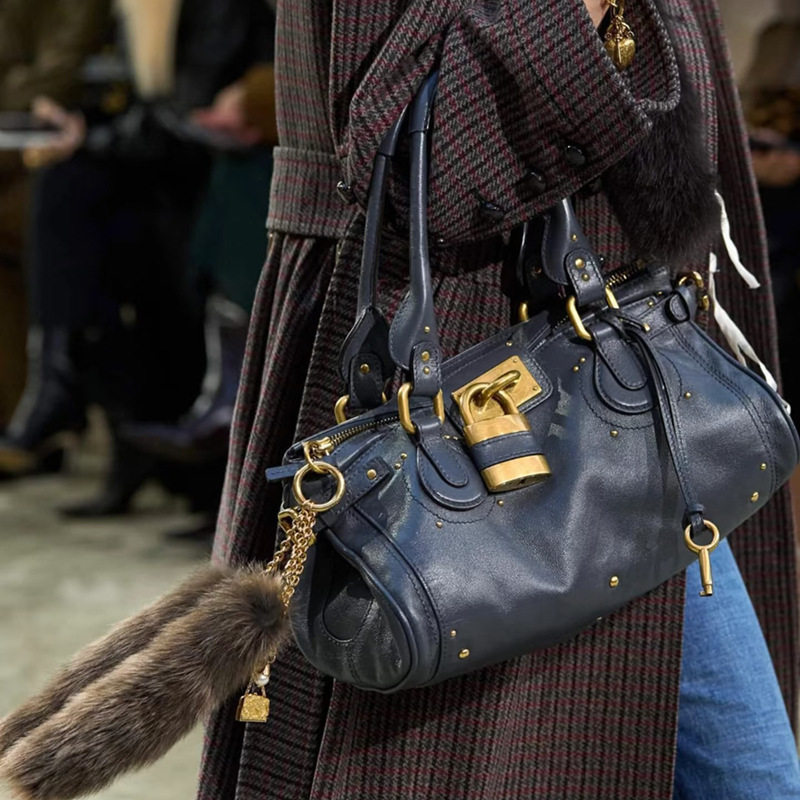 designer 2026 new Mid - century style niche, retro versatile lock - head bag, rivet pillow bag winter 2026 handbag for commuting trendy for women