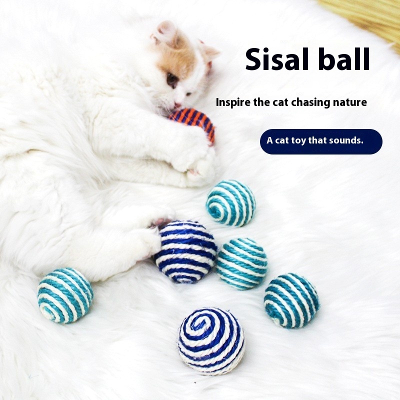 Cat with self satisfied, nibbg on multi-color playful cat toy, sisal ball, grinding teeth, making sound hemp rope tail ball