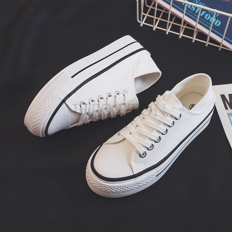 Thick Soled Round Toed Canvas Shoes with Low Cut and Shallow Mouth Two Pairs Worn and One Foot Pedaled with Small White Shoes