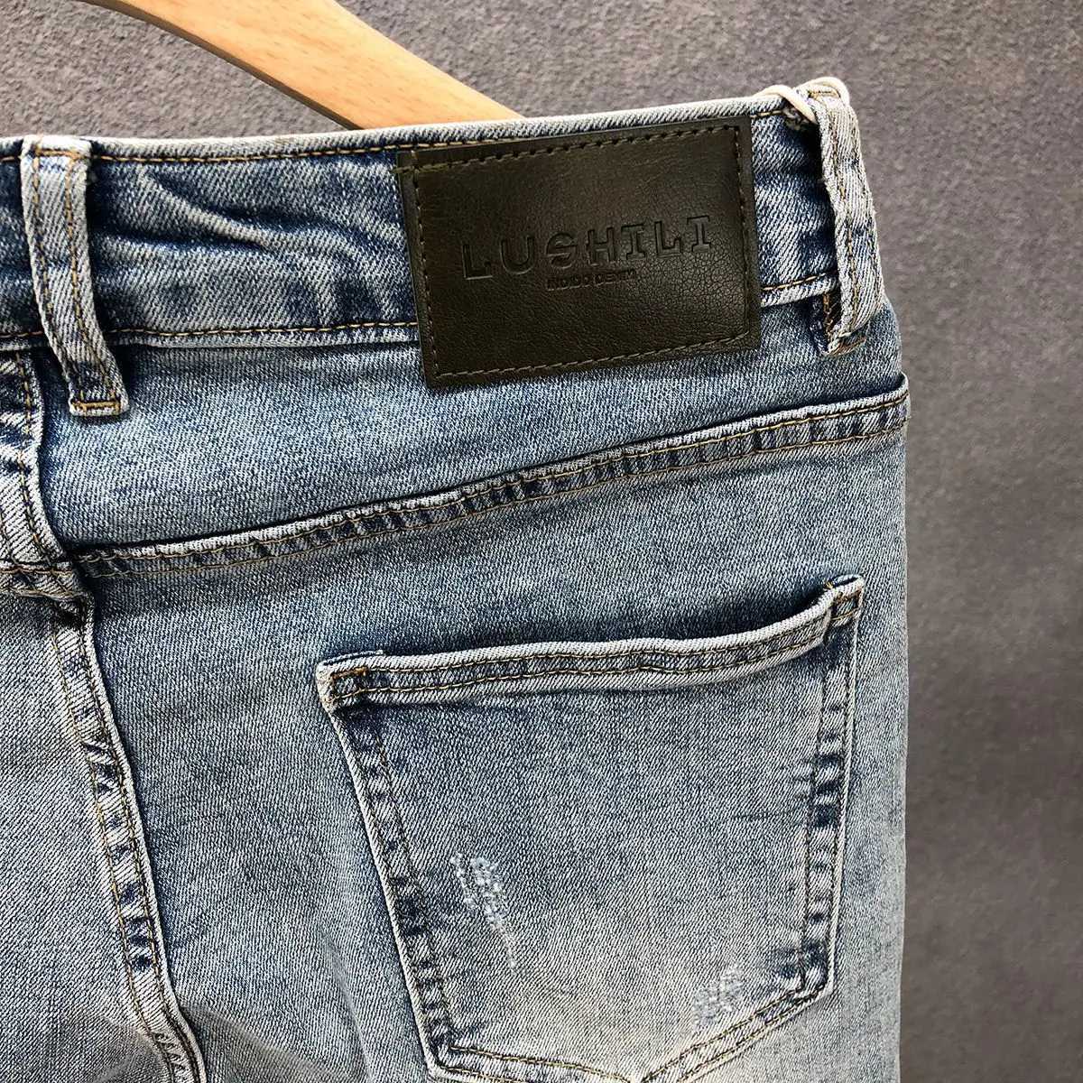 Fashion designer mens slim fit jeans with ink splatter and cracked holes suitable for spring and autumn casual wear strict fashion pencil pants CL2409