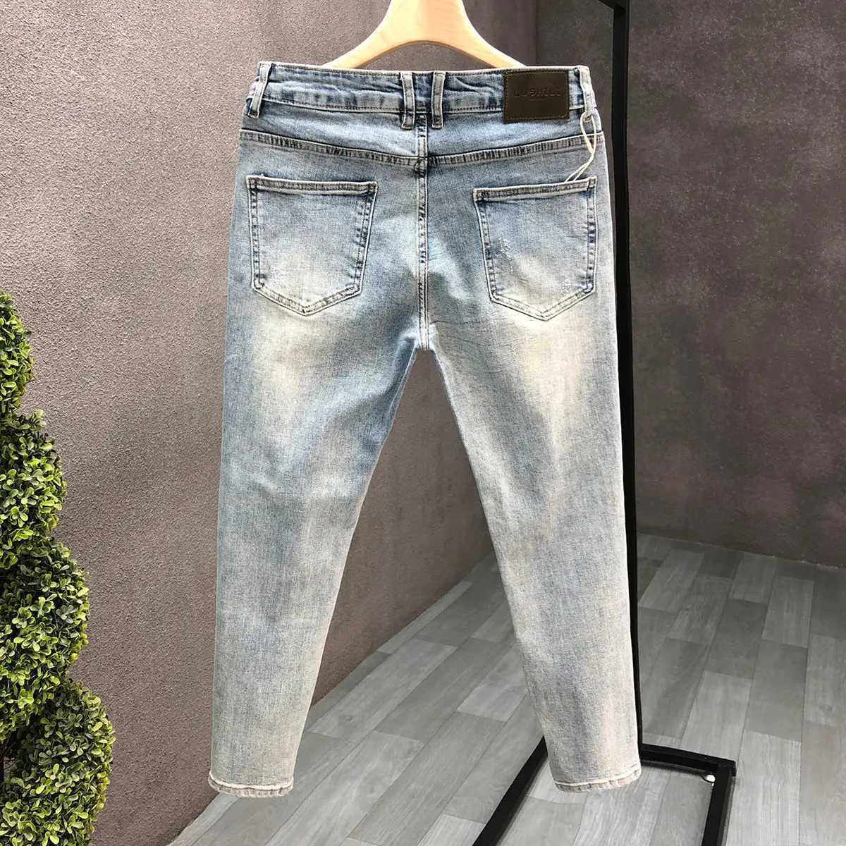 Fashion designer mens slim fit jeans with ink splatter and cracked holes suitable for spring and autumn casual wear strict fashion pencil pants CL2409