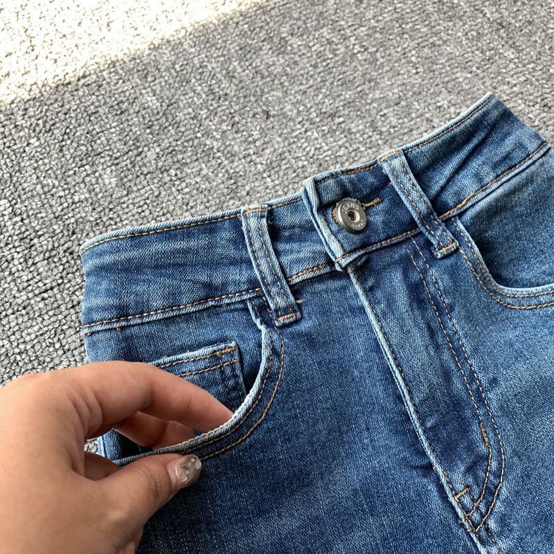 Designer women's blue flared jeans, high waisted sexy girl, slim fit, elastic, raised hips, rough edges, floor hugging, slimming pants