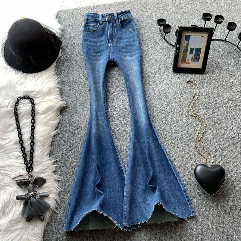 Designer women's blue flared jeans, high waisted sexy girl, slim fit, elastic, raised hips, rough edges, floor hugging, slimming pants