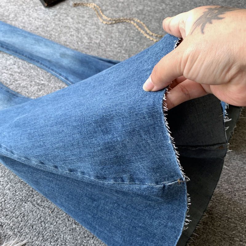 Designer women's blue flared jeans, high waisted sexy girl, slim fit, elastic, raised hips, rough edges, floor hugging, slimming pants