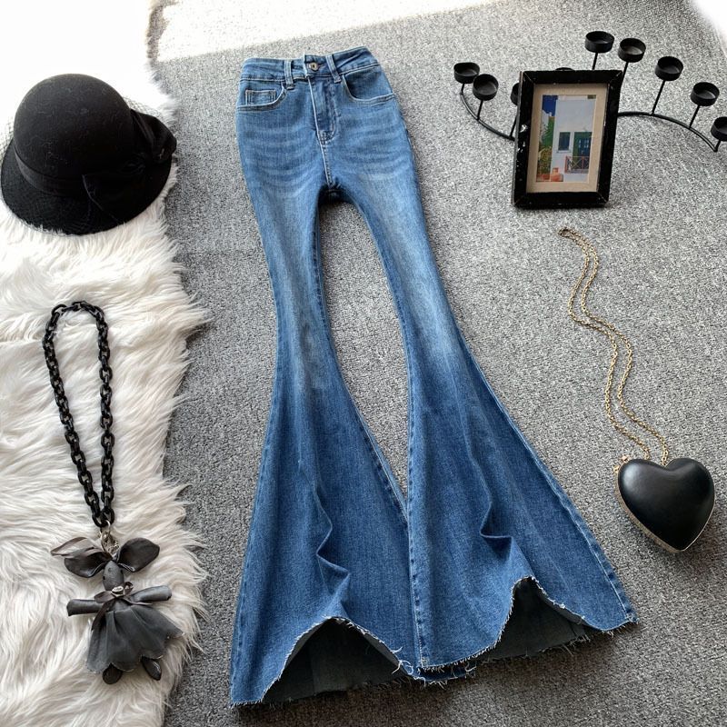 Designer women's blue flared jeans, high waisted sexy girl, slim fit, elastic, raised hips, rough edges, floor hugging, slimming pants