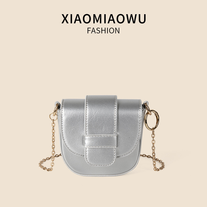 Mini new solid color saddle with niche texture, flip cover magnetic buckle crossbody bag, women's summer chain PU shoulder bag
