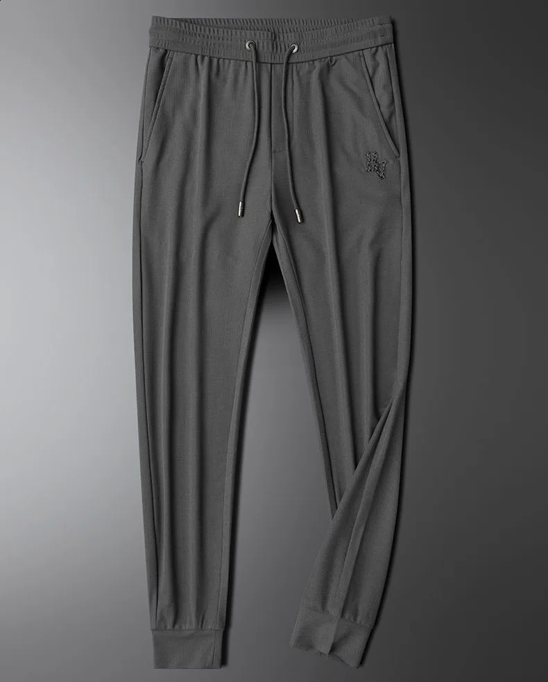 Comfortable and soft molded ice silk casual pants for spring summer suitable mens small leg knitted vertical striped sports 240821