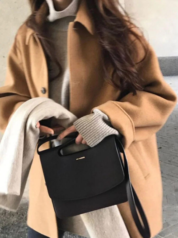 Artificial wool coat womens autumn and winter long sleeved lapel mid length jacket womens Korean fashion preparatory shoulder strap jacket 240828