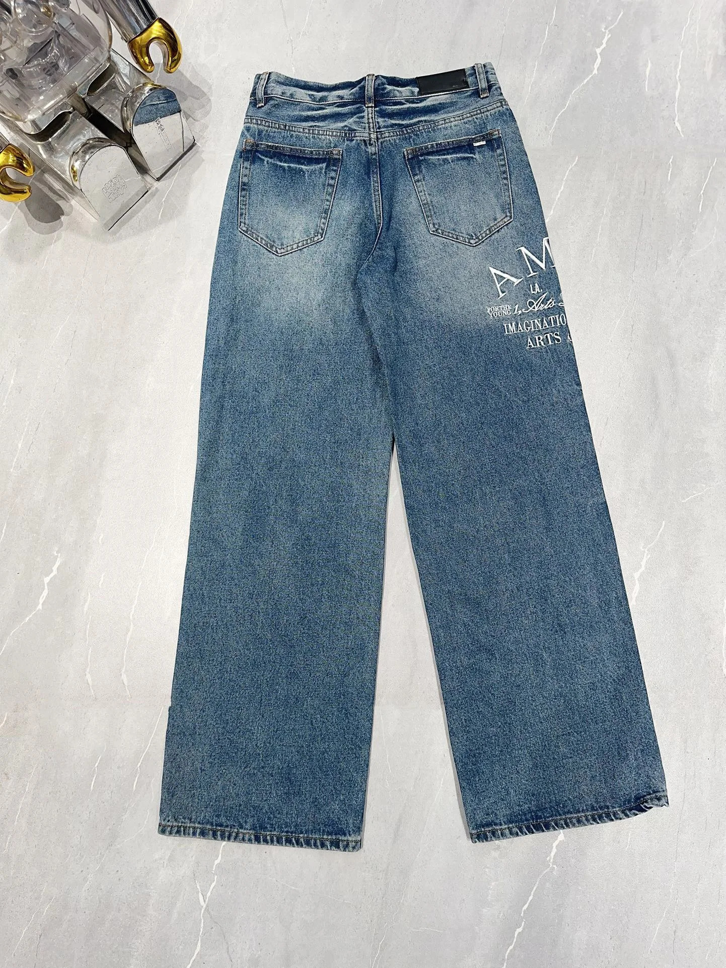 The latest blue wide leg mens tight jeans suitable for pocket denim pants with letter embroidery and tear holes on the knees 240829