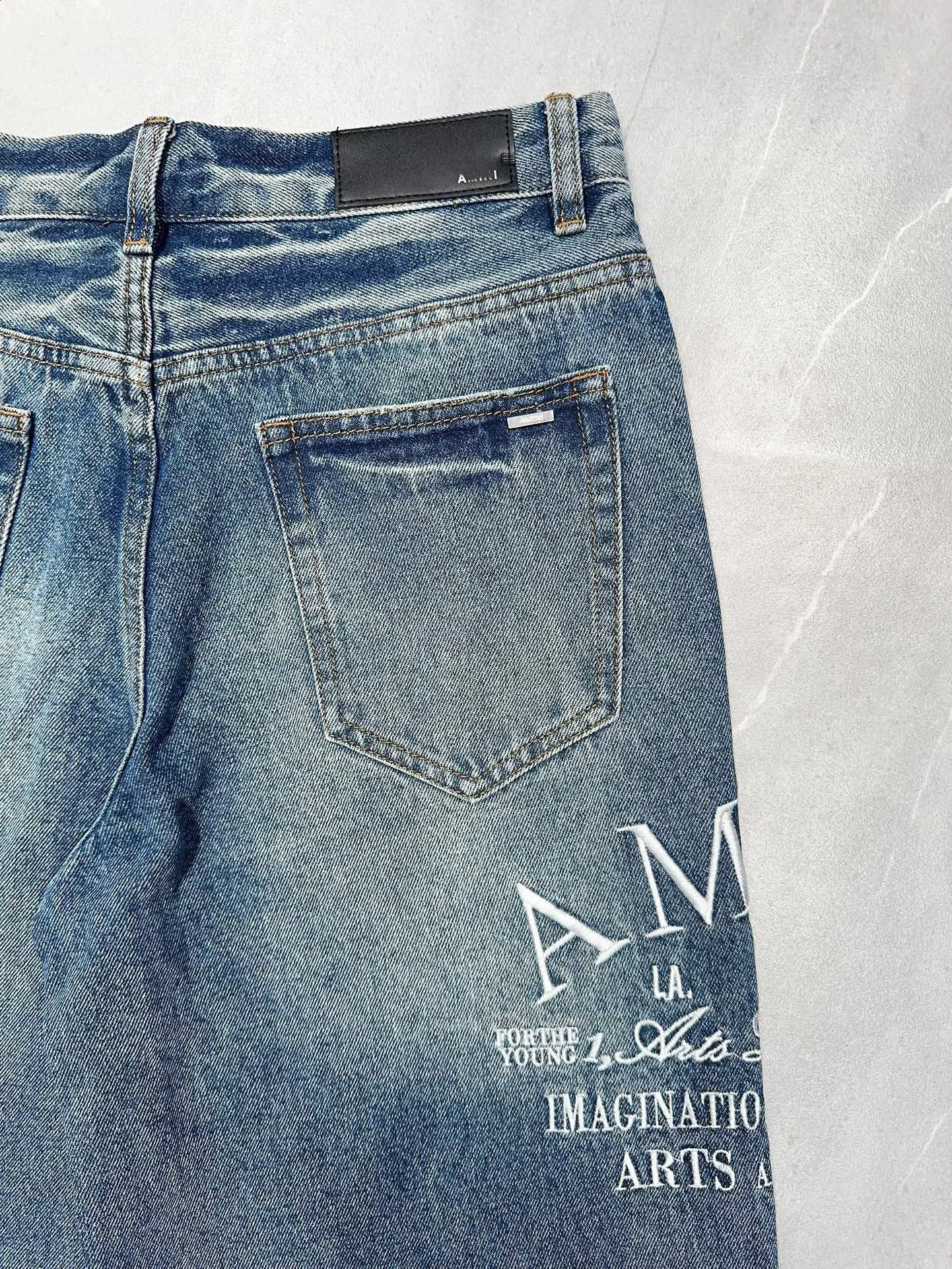 The latest blue wide leg mens tight jeans suitable for pocket denim pants with letter embroidery and tear holes on the knees 240829