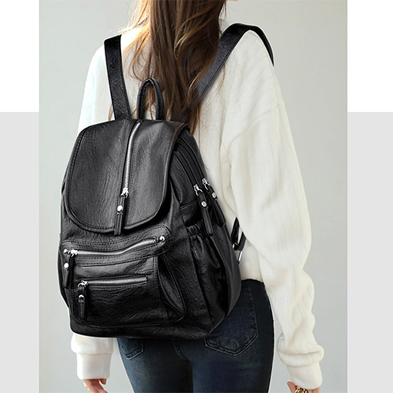 leather backpack with multiple zipper pockets and hardware, fashionable and minimalist women's bag
