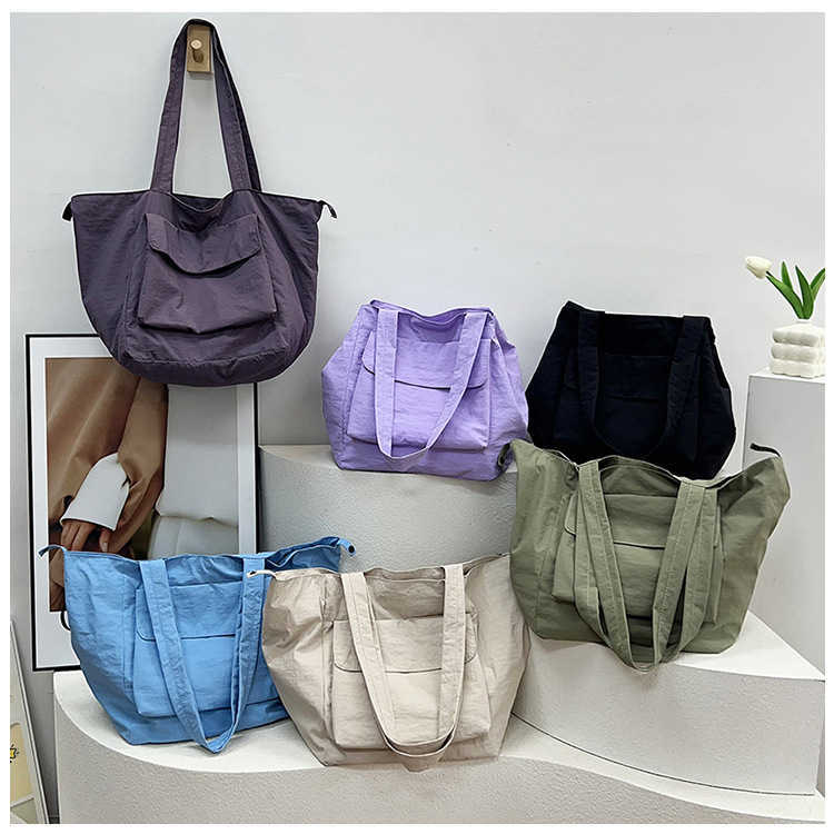 New waterproof nylon large capacity portable shoulder bag for men and women, casual travel workwear style commuting tote bag