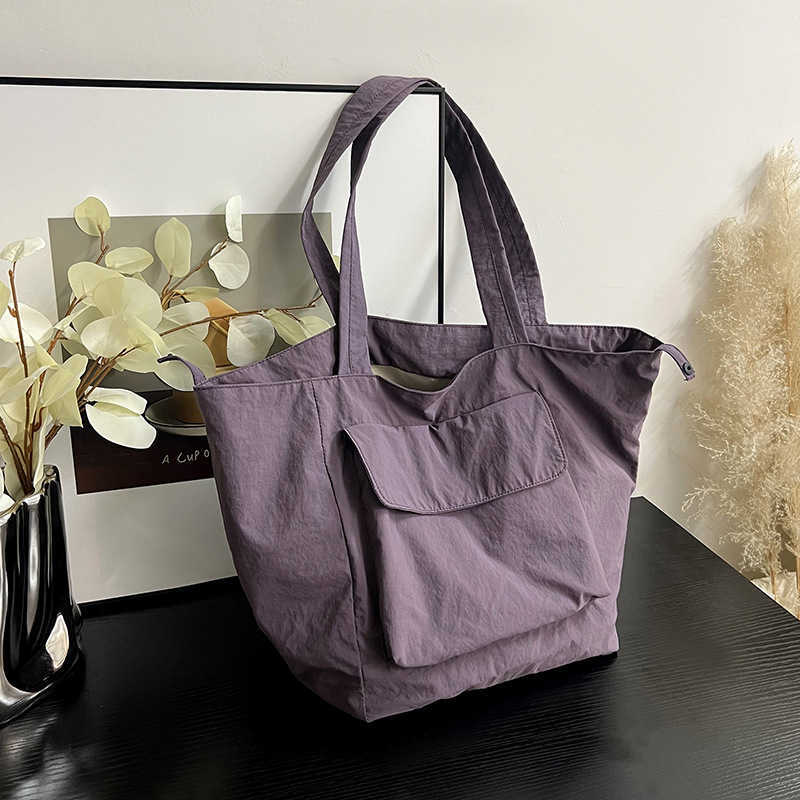 New waterproof nylon large capacity portable shoulder bag for men and women, casual travel workwear style commuting tote bag