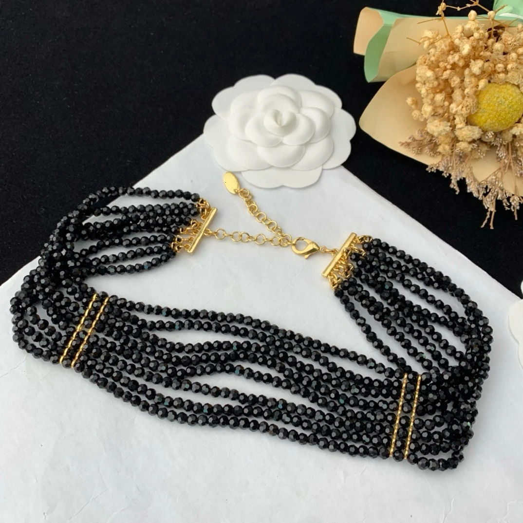 Black multi-layer glass bead necklace woven with elegant flowers paired with a skirt 241205