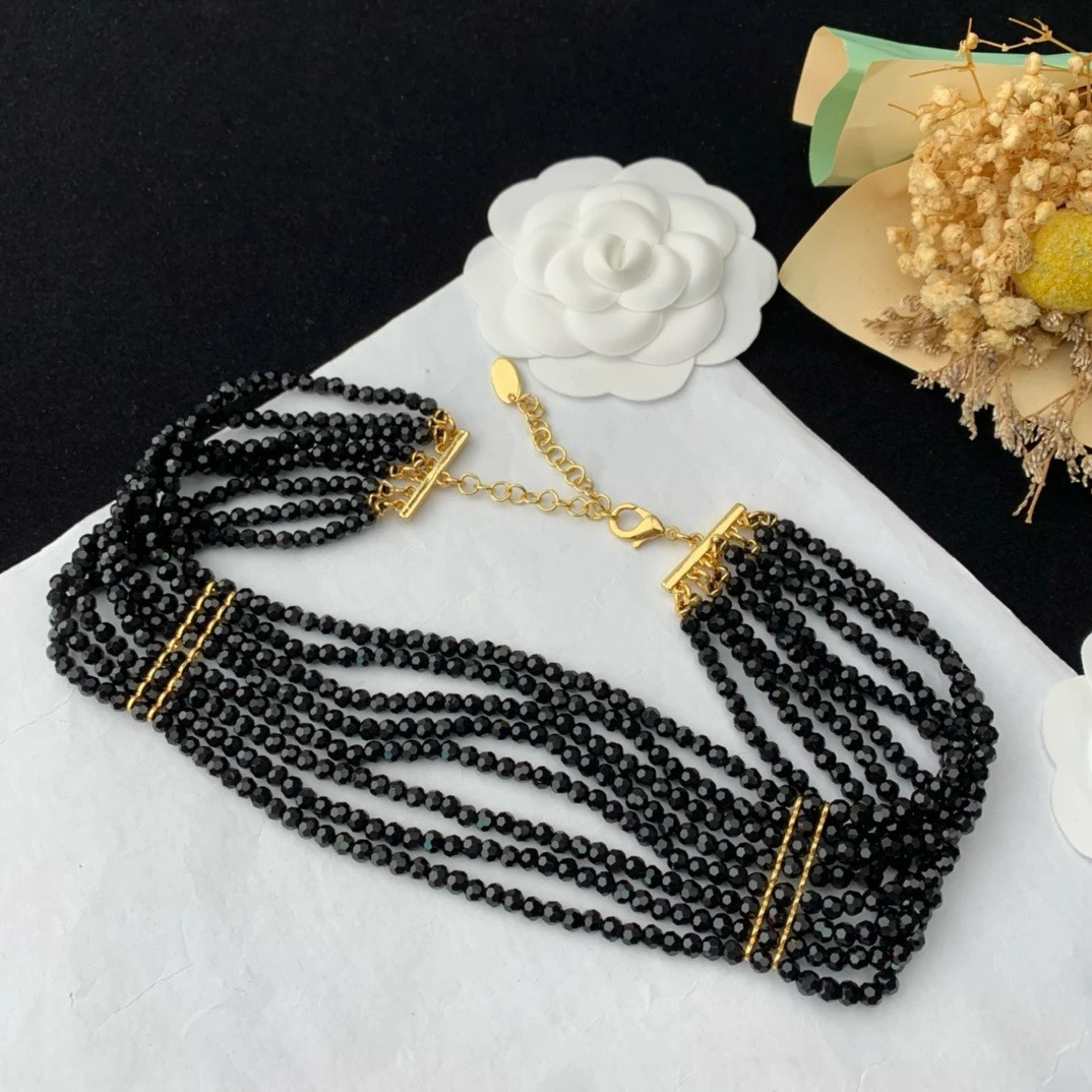 Black multi-layer glass bead necklace woven with elegant flowers paired with a skirt 241205