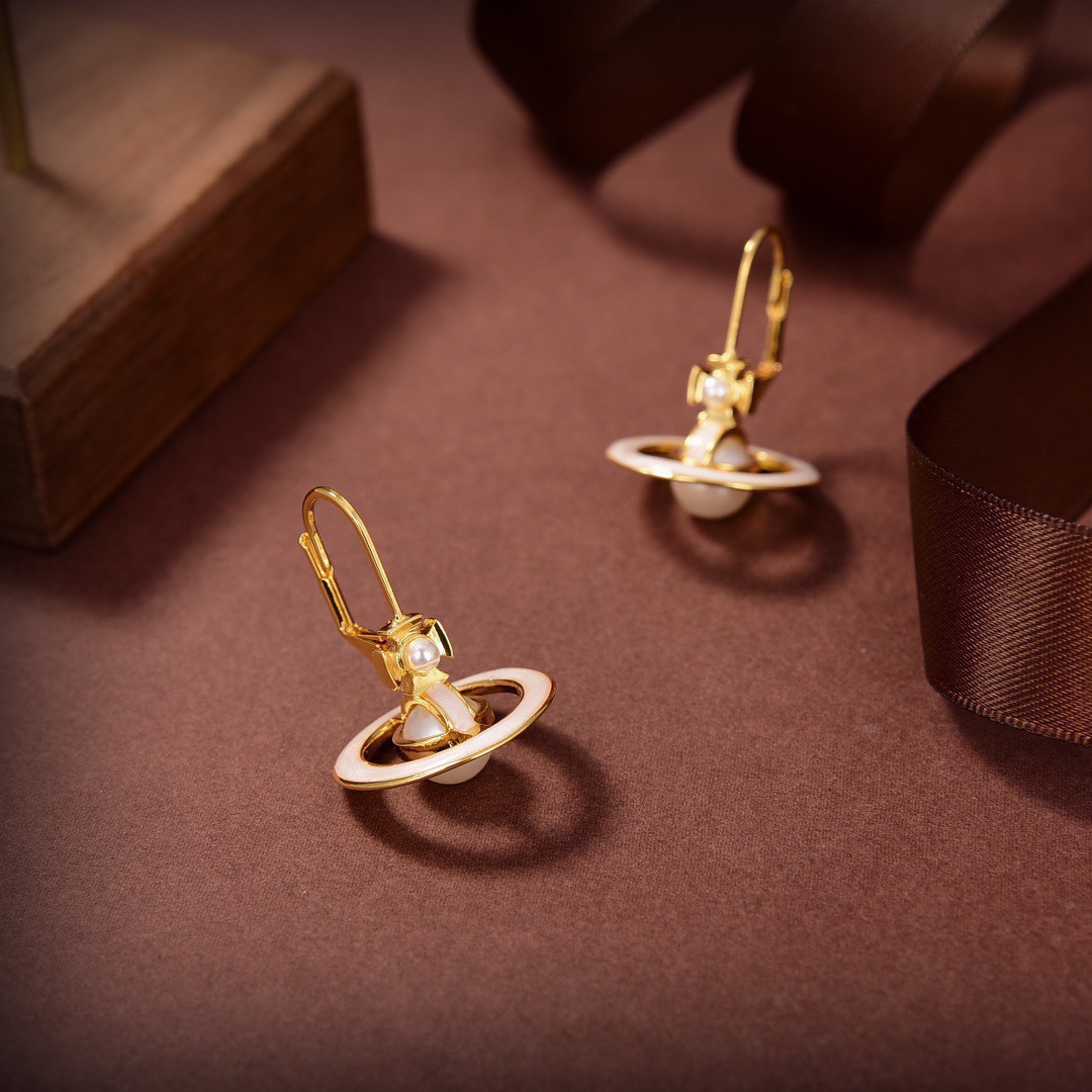 Stylish and delicate orb pendant earrings. Gold and white matching. Women's glamour earrings. Luxury party jewelry accessories.