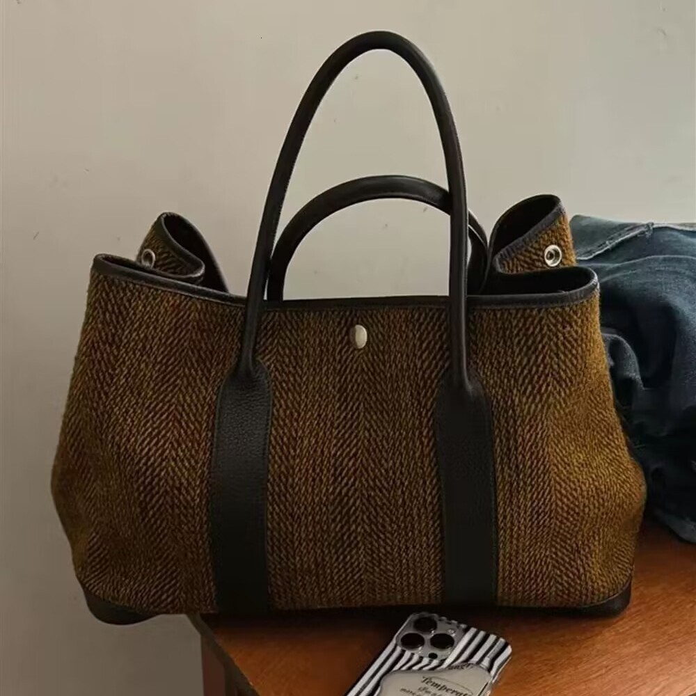 2025 designer niche autumn and winter new women fashion temperament woolen shoulder handbag large simple bag versatile backpack