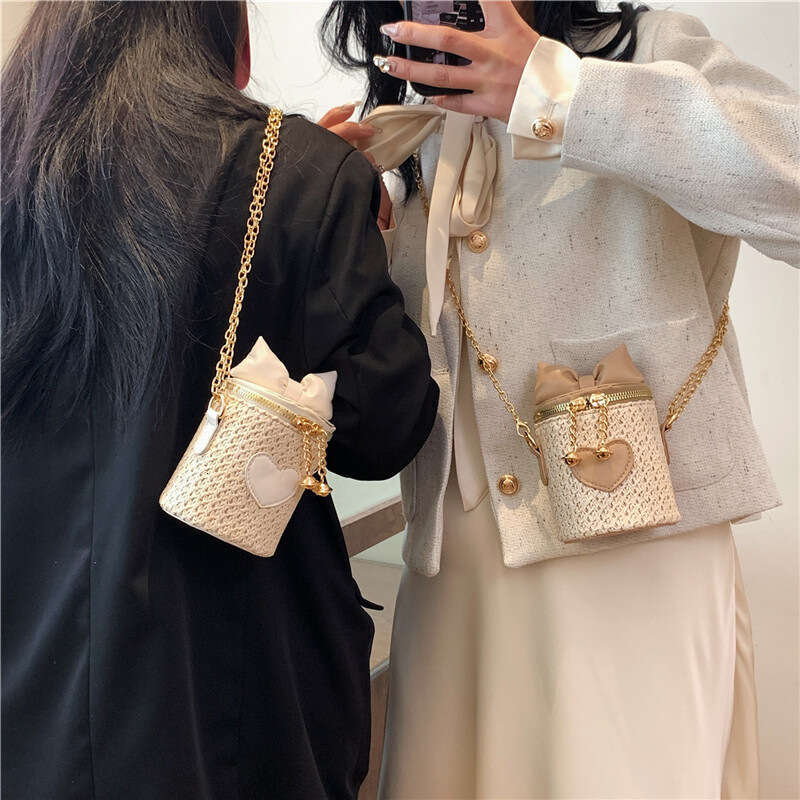 2025 New Bohemian Mini Splicing Straw Water Bucket Women's Crossbody Woven Chain Bow Bag