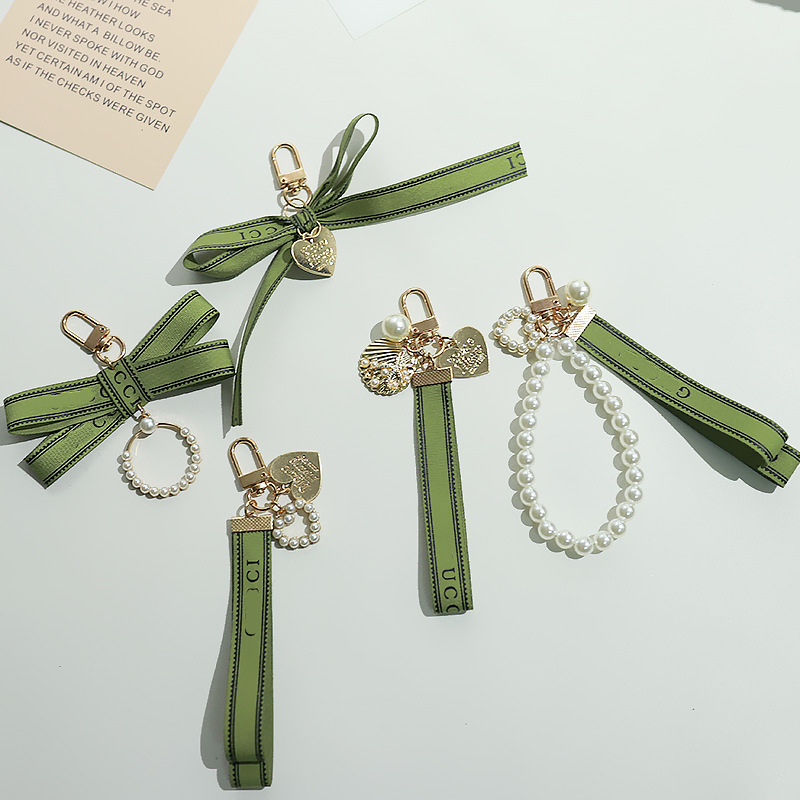 Designer keychain Pearl Bow bag charm keychain Earphone Case Jewelry Pendant Ins Simple Style Love Ribbon Car Keychain Bag Hanger wallet ornament